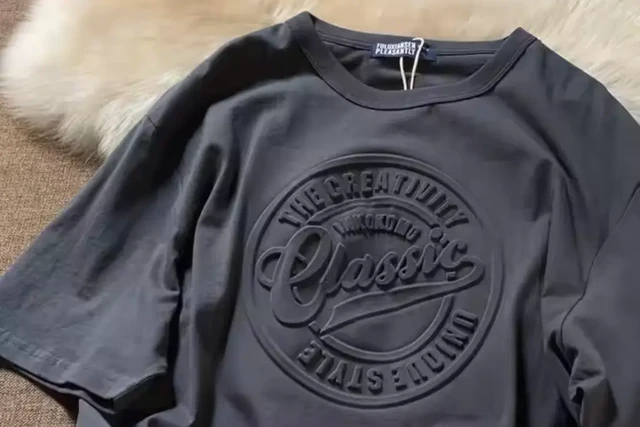 A T-Shirt with a custom embossed company logo on the front.