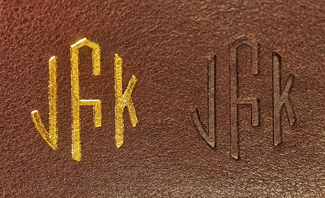 A piece of leather showing a Gold Foil Stamp vs. a Deboss