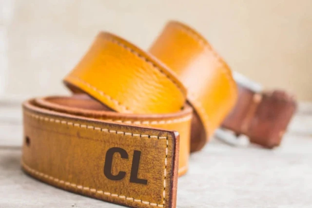 A leather belt with an example of laser engraving initials